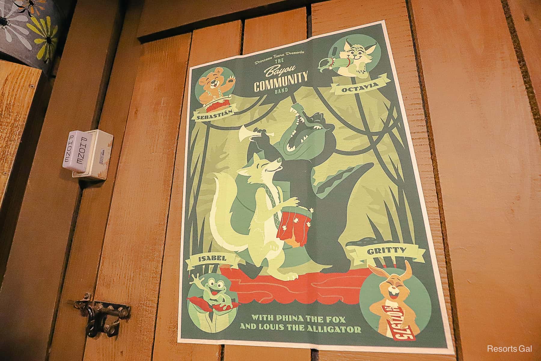 a green poster with Louis and other members of the band on Tiana's Bayou Adventure 