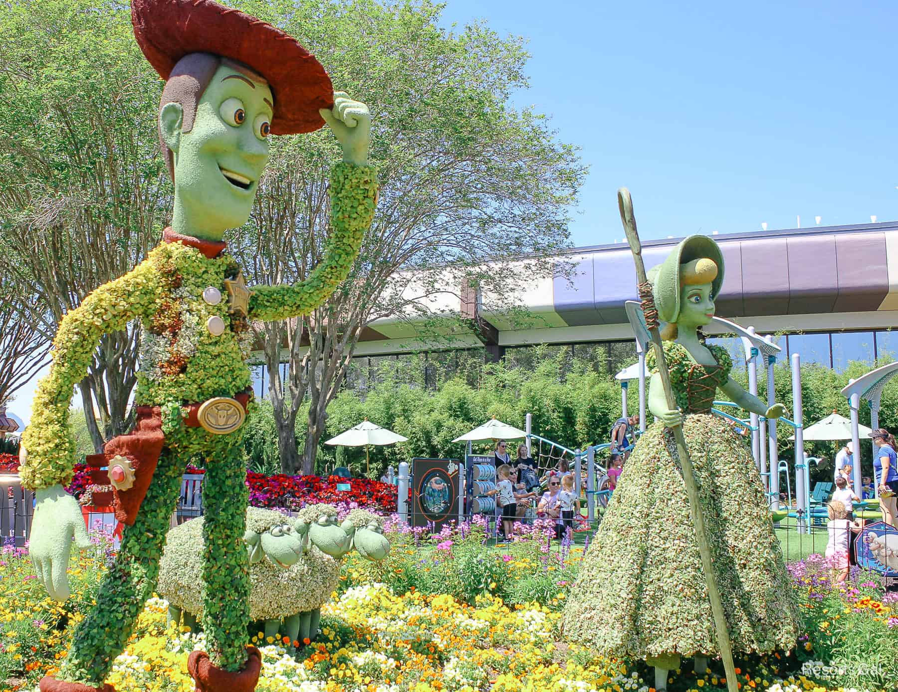 Woody tips his hat, Bo Peep and three sheep in topiary form at Epcot 