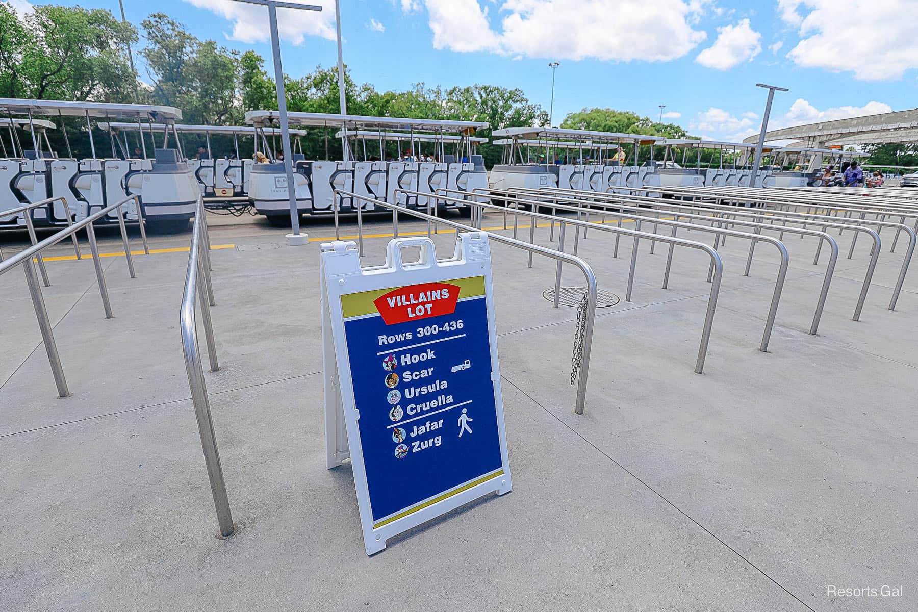 a sign that indicates to wait here for the Villains Lot parking trams at the TTC 