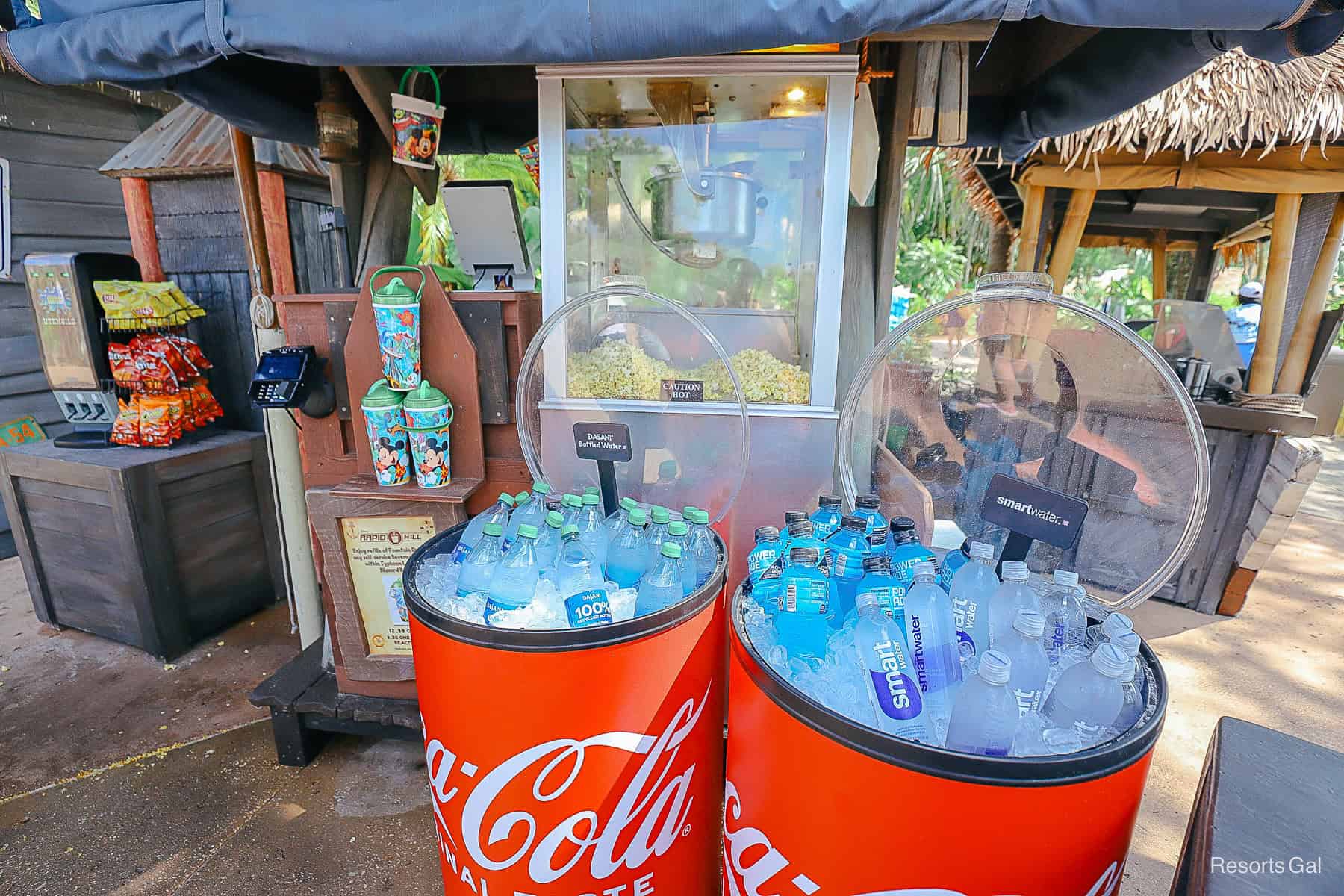 a snack stand with various bottled beverages 