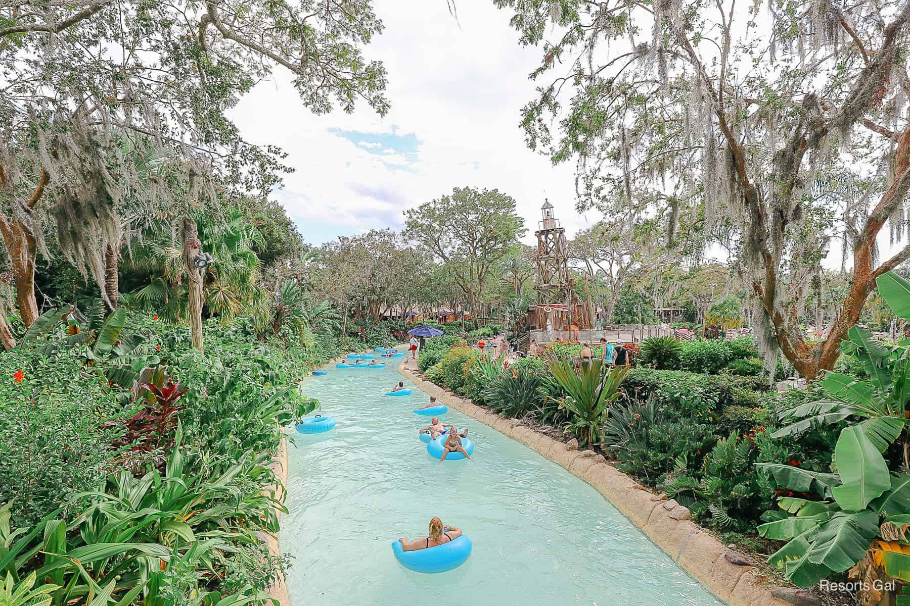 guests floating down the lazy river in half cut out inner tubes 