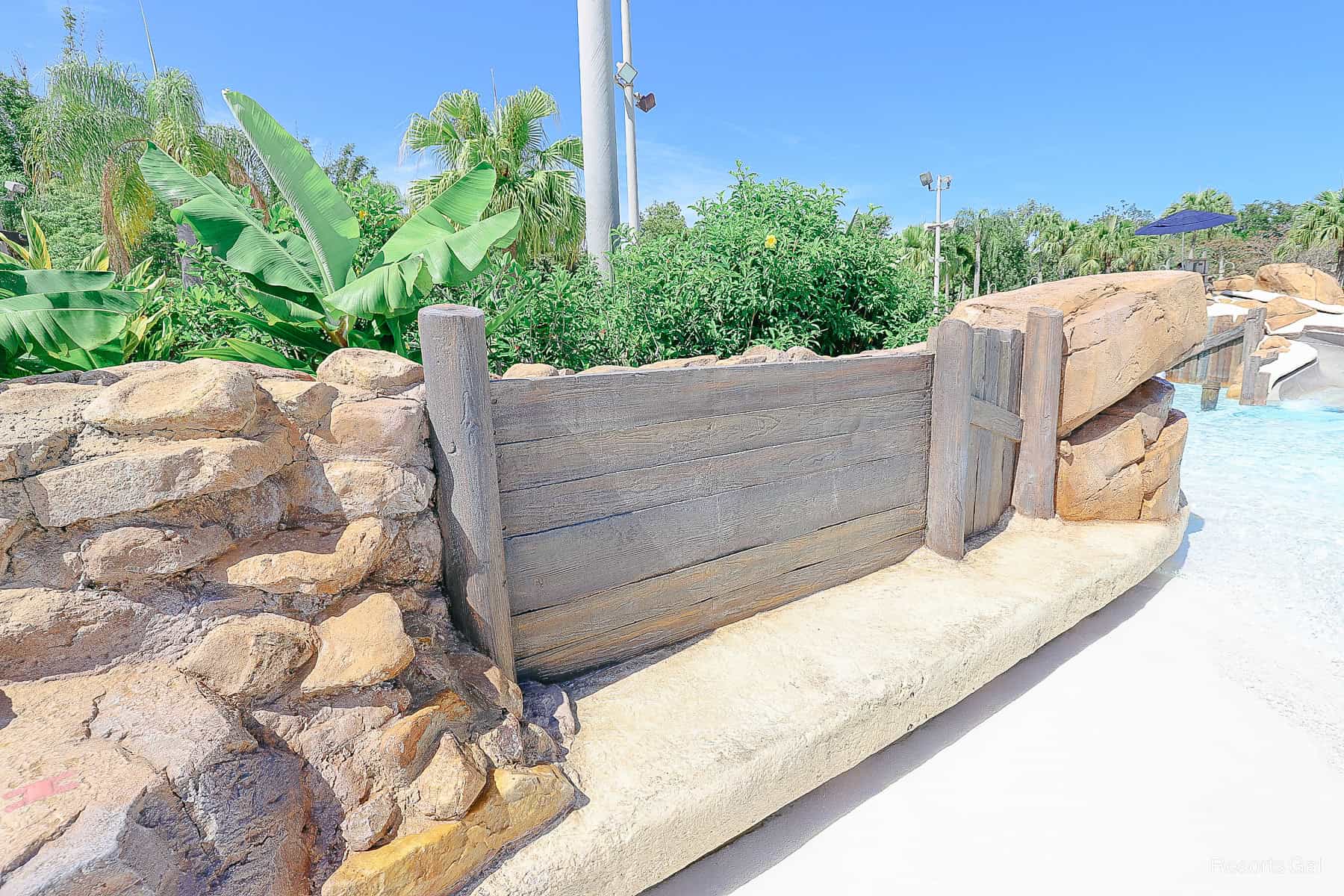 a bench where parents can sit in the wave pool near the Bay Slides 