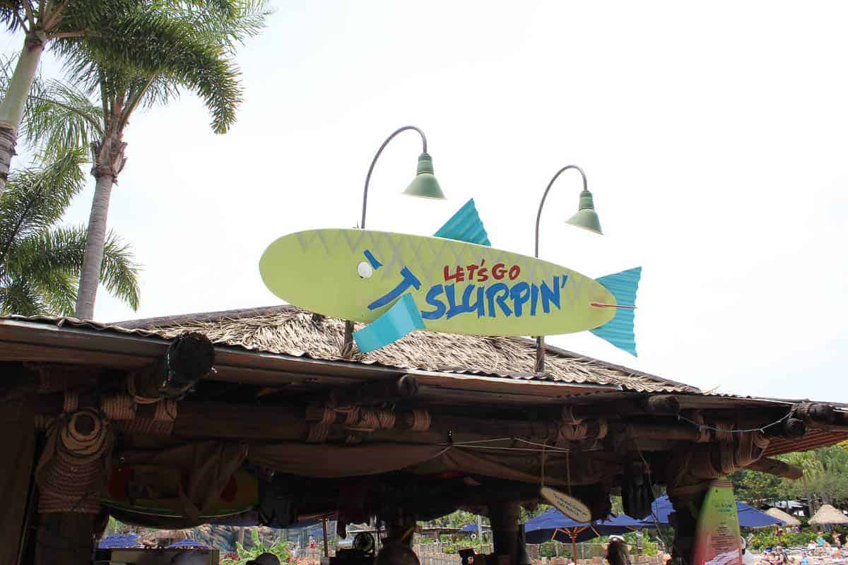 the signage for Let's Go Slurpin' Surf Pool Bar at Typhoon Lagoon 