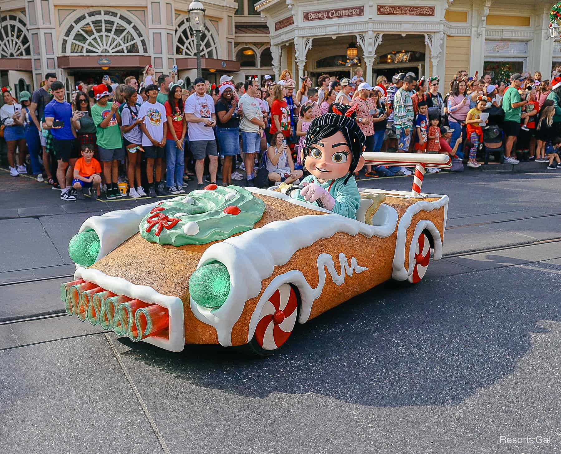 Vanellope riding a gingerbread car in the Christmas Parade at Magic Kingdom. 