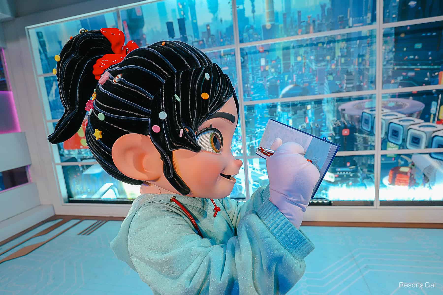 Vanellope from Wreck It Ralph signs her autograph. 