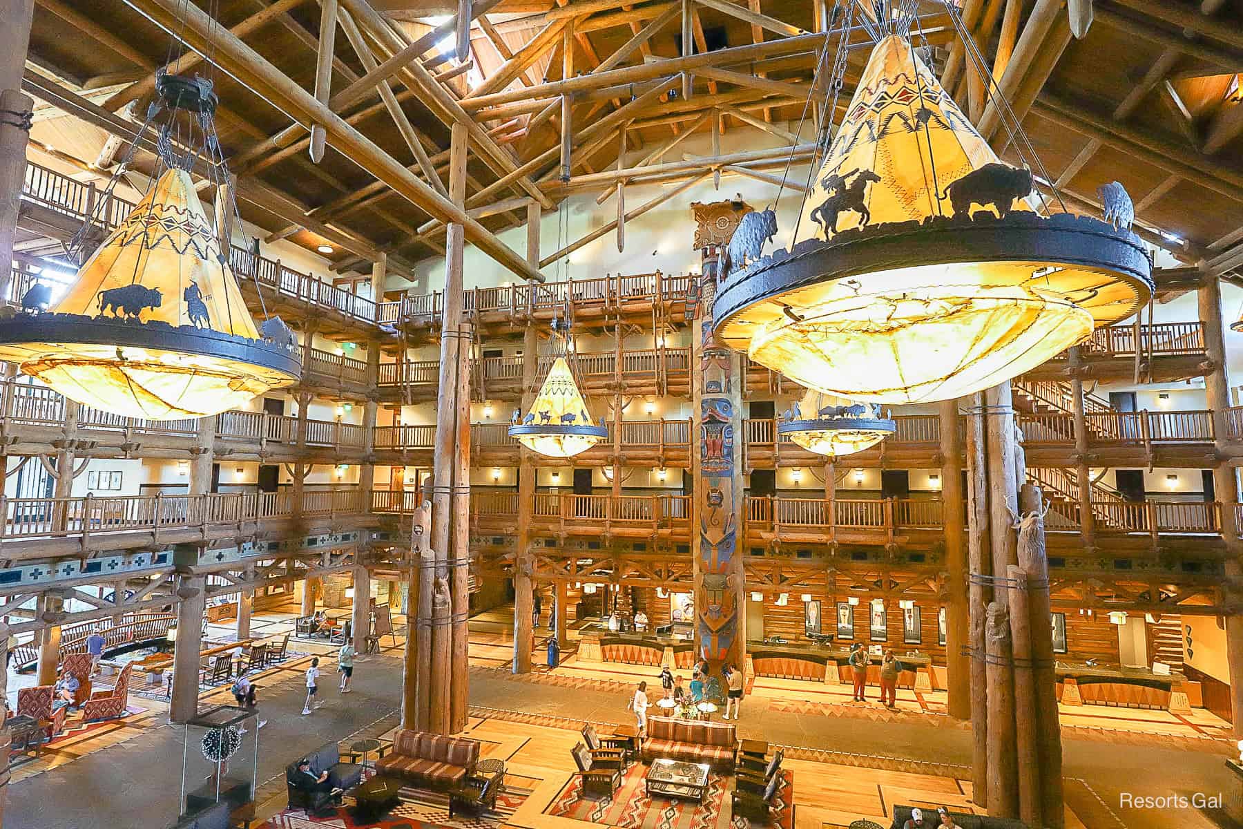 the light fixtures in the Wilderness Lodge lobby feature Native American scenes and are shaped like teepees in the center 