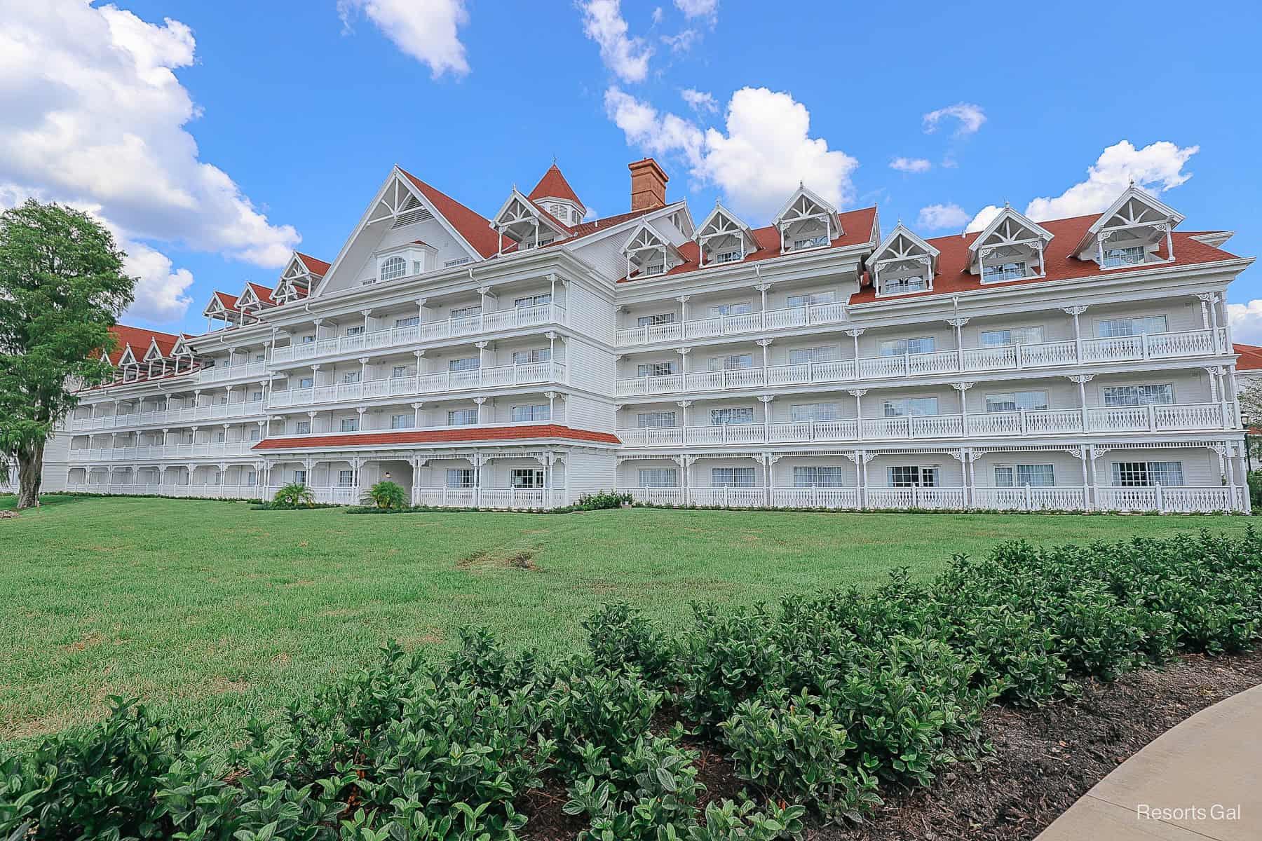 a pretty image with green grass and blue sky backdrop of a building at the Grand Floridian 