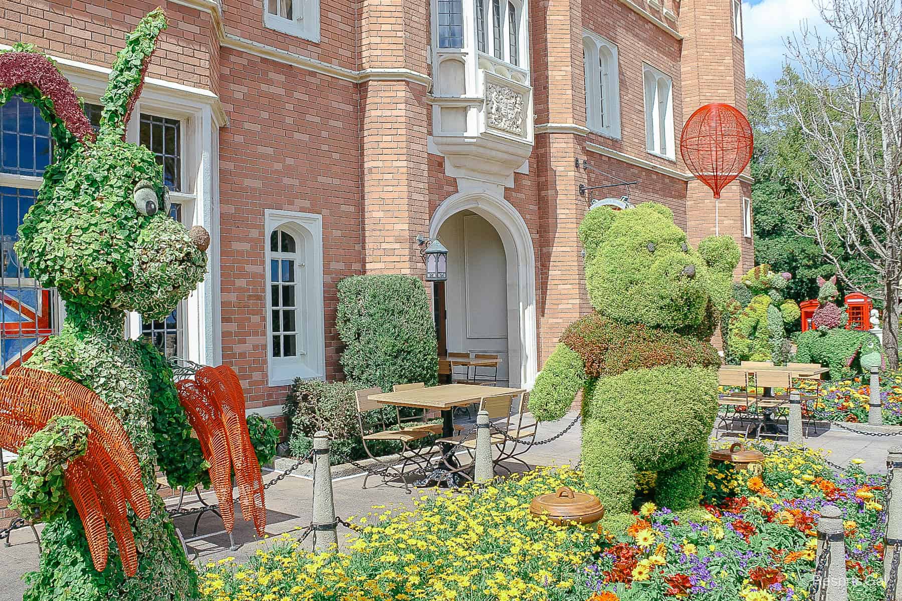 all four Winnie the Pooh and Friends in a staggered photo Left to Right Rabbit, Winnie the Pooh, Tigger, Eeyore, and Piglet 