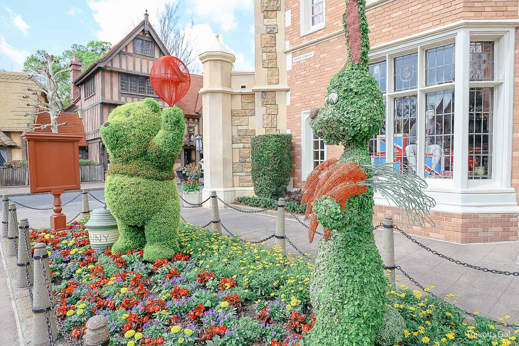 Winnie the Pooh with a hunny pot and Rabbit at an angle in front of the United Kingdom Pavilion (Topiary Forms) 