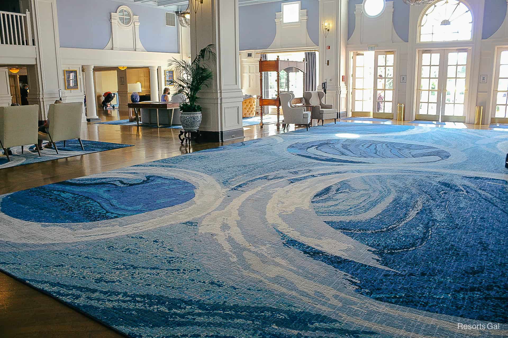 a massive rug in blue and white with a hidden Mickey created out of a swirl pattern 