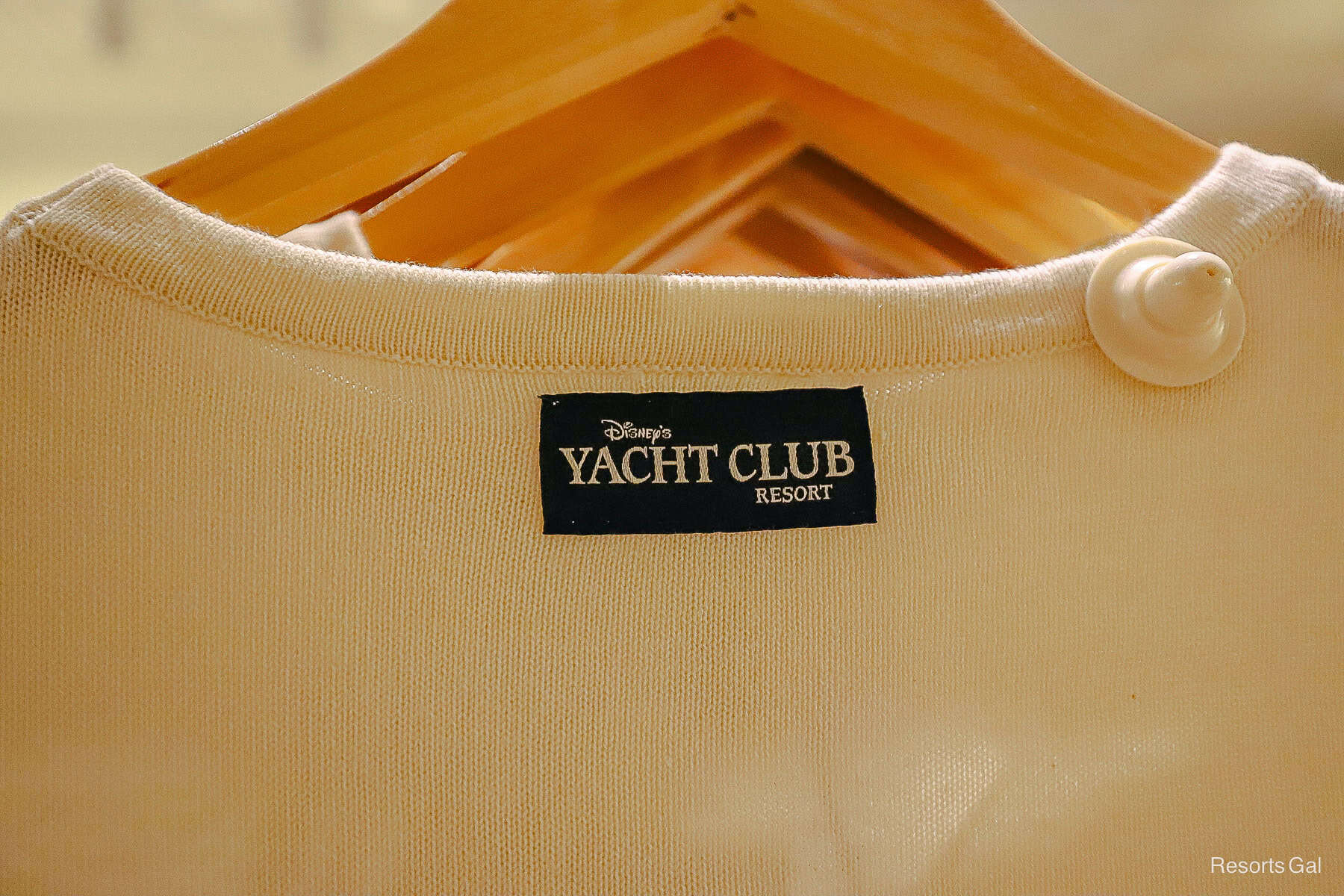 a tag on a sweater in navy that says the Yacht Club Resort 