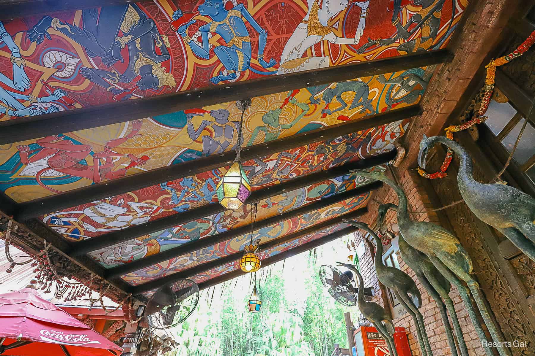 a mural painted ceiling over a private dining area
